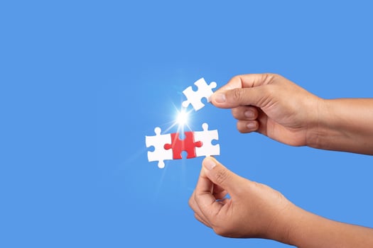 Hands holding jigsaw puzzles piece with clear blue background, success business, solution strategy, teamwork partnership concept photo