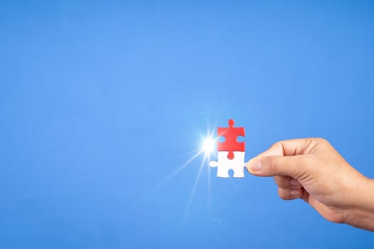 Hands holding jigsaw puzzles piece with clear blue background, success business, solution strategy, teamwork partnership concept photo