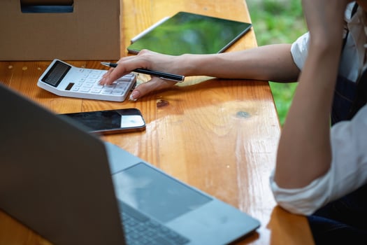 Young businesswoman using a tablet to check online product sales photo