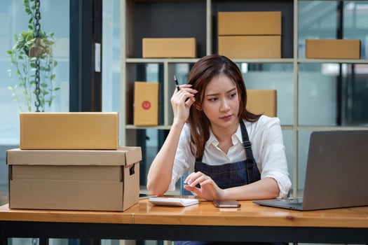 Asian businesswoman worried about unordered online sales photo
