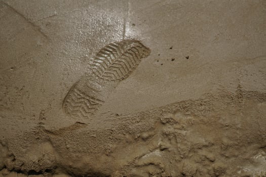footprint on raw concrete layer photo