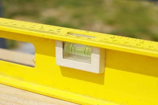 Yellow building level . working tool on wooden background photo