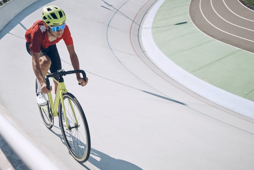Confident man in sports clothing cycling on track outdoors photo