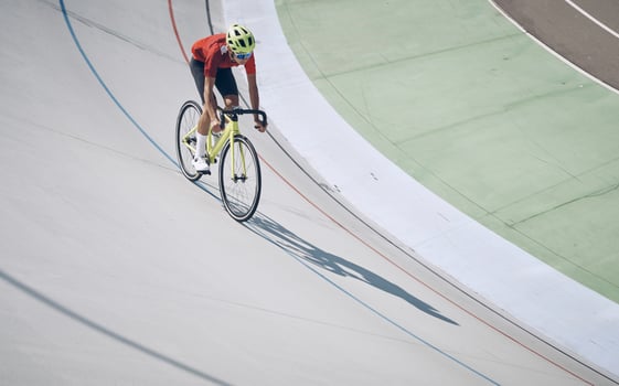 Top view of man in sports clothing cycling on track outdoors photo