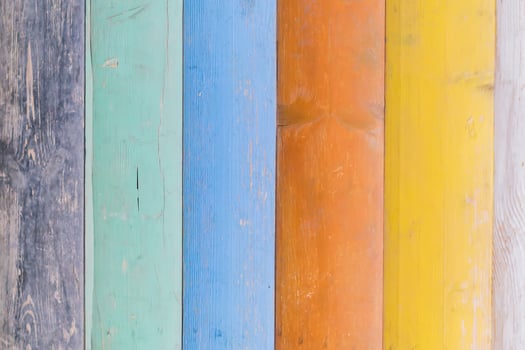 Multicolored wooden background texture. Close up of colorful fence photo