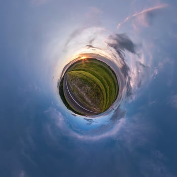 Little planet transformation of spherical panorama 360 degrees. Spherical abstract aerial view in field in nice evening with awesome beautiful clouds. Curvature of space. photo