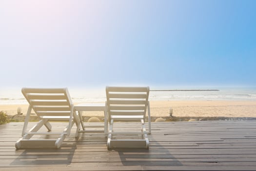 Bench on the beach at yellow sunset photo