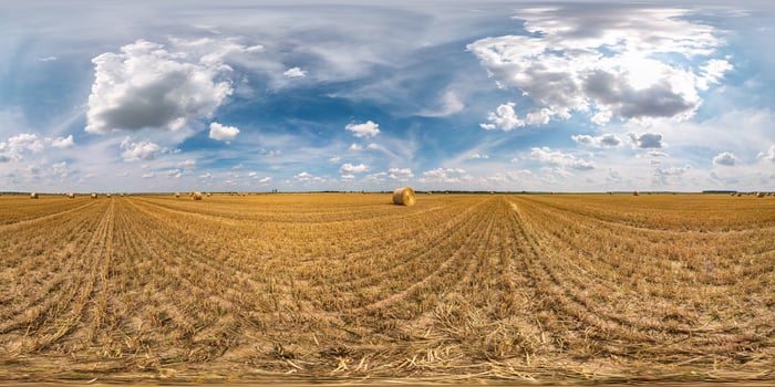 full seamless spherical hdri panorama 360 degrees angle view among harvested rye and wheat fields with Hay bales in summer day with beautiful cirrocumilus clouds in equirectangular projection photo
