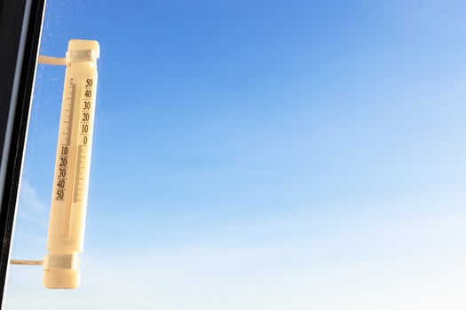 outdoor thermometer on home window and blue sky photo
