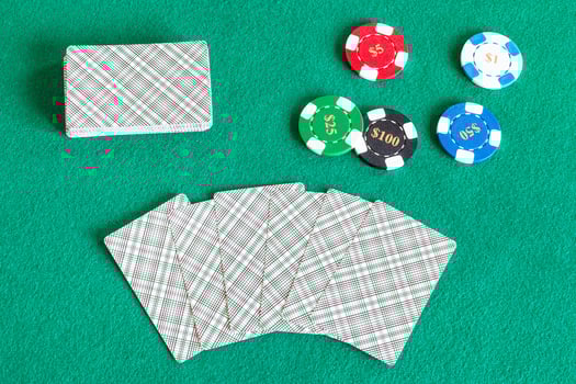 card decks and casino tokens on green table photo