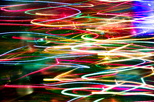 Abstract burred texture background of colorful bokeh motion. Long exposure of small neon lights photo