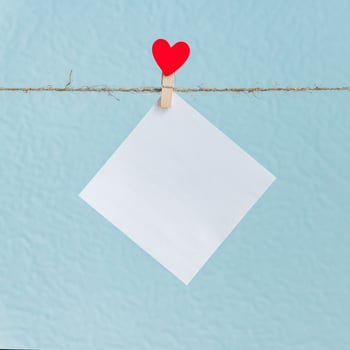 Blank cards on pins with red hearts. Mockup for text and blue background for Valentines Day greetings photo