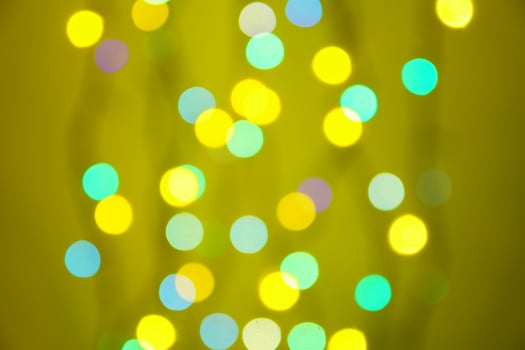 abstract blurred lights on background in green, orange and yellow- christmas celebration concept photo