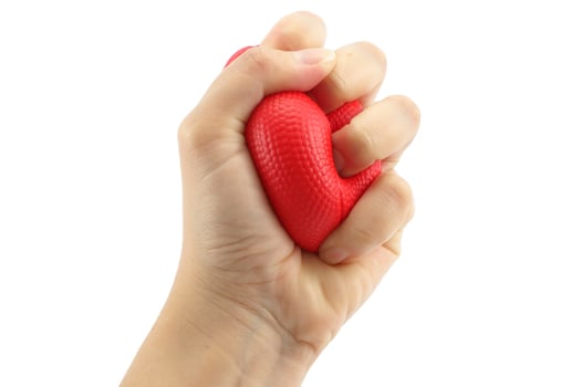 Woman hand squeezing a stress ball  on white background photo