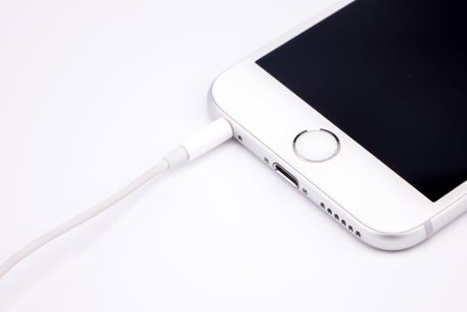 Smart phone  and headphone on white table photo