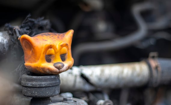 Broken car after a traffic accident. Auto insurance concept. Broken and damaged car. A toy in a burned-out car among spare parts and pipes. photo