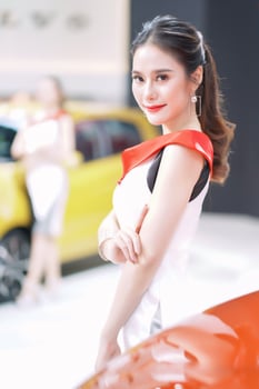 Nonthaburi, Thailand - DEC 3, 2019 Unidentified model poses with a car at The 36th Motor Expo Thailand 2019 at IMPACT Arena, Muang Thong Thani, Nonthaburi, Thailand. photo