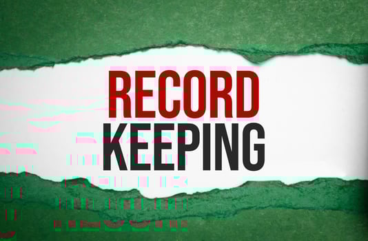 RECORD KEEPING text on green torn paper photo