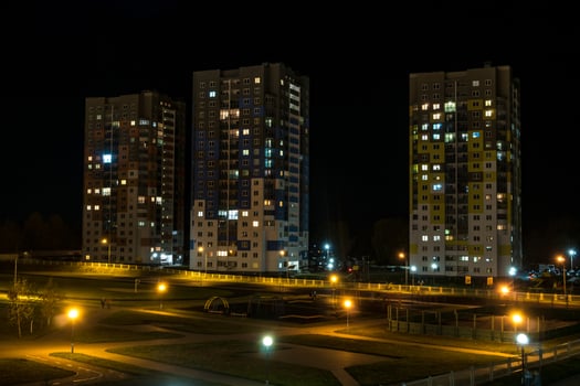 Night panorama of Light in the windows of a multistory building. life in a big city photo