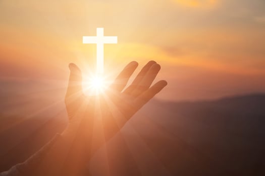 Silhouette of human hands palm up praying and worship of cross, eucharist therapy bless god helping, belief, forgiveness, freedom, hope and faith, christian religion concept on sunset background. photo