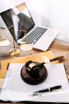 Business and lawyers discussing contract papers with brass scale on desk in office. Law, legal services, advice, justice and law concept picture with film grain effect photo