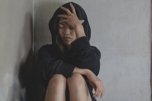 Depressed and hopeless teenage girl sitting alone after using drugs, Drugs addiction and withdrawal symptoms ,  No to drugs concept. International Day against Drug Abuse. photo