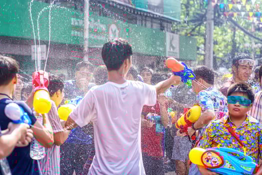 Siam Square, Bangkok, Thailand - APR 13, 2019 short action of people joins celebrations of the Thai New Year or Songkran in Siam Square. photo
