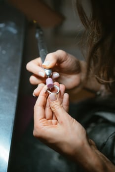 girl master processes the metal plate in the home workshop photo