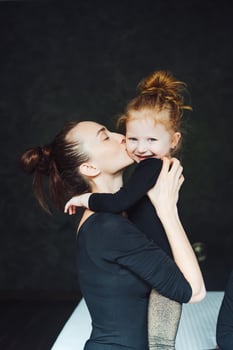 Mom and daughter have fun on the bed photo