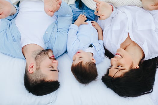 Happy family relaxing together on the mattress photo
