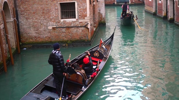 Venetian channel with ancient houses and boats photo