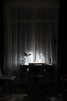 workplace in the room with the lamp on photo