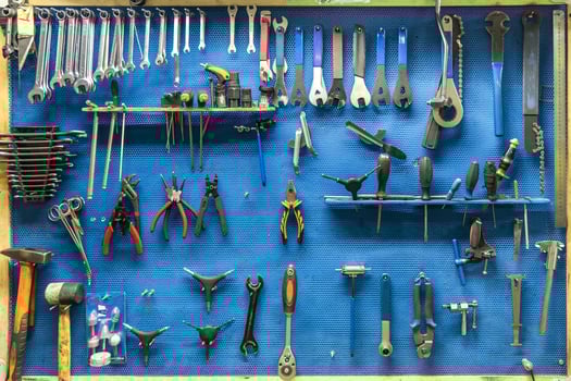 set of repair tools in a modern bicycle and car repair shop on a blue background photo