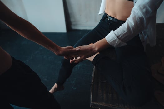 Two girls hold hands in an art workshop photo