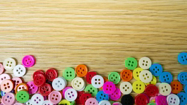 The  button multicolour  on wood table for background concept photo