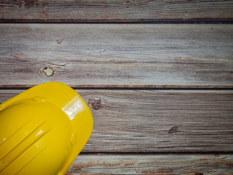 Hard Hats Yellow Cap Mine Safety Appliances on  wood table photo