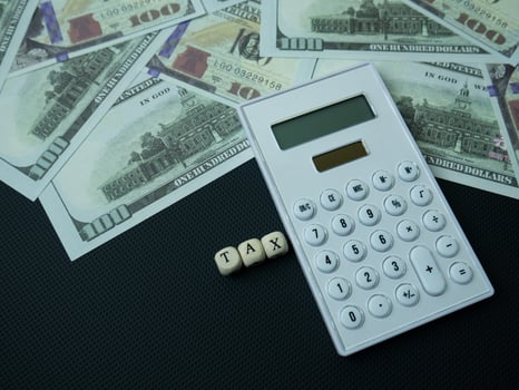 The wood text and calculator on black background for business content photo