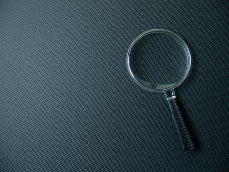 The Magnifying glass on black background for search concept photo