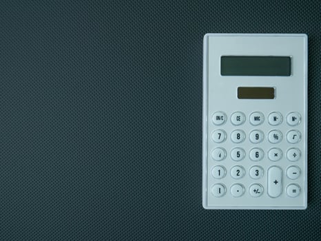 The white calculator on black background for business content. photo