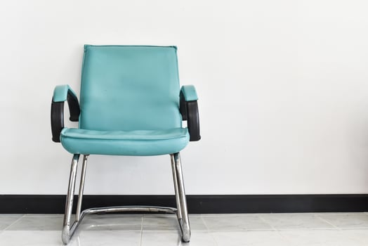 Blue chair decorative standing in interior with white wall photo