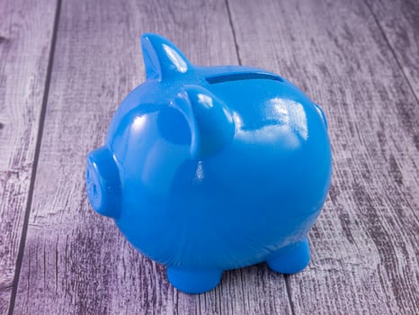 blue piggy bank on wood table for business concept photo