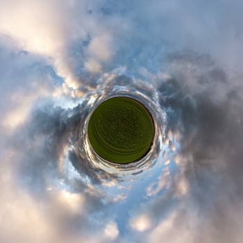 Little planet transformation of spherical panorama 360 degrees. Spherical abstract aerial view in field with awesome beautiful clouds. Curvature of space. photo