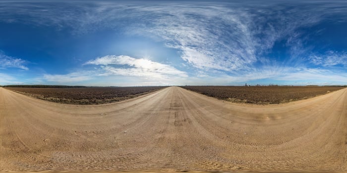 full seamless spherical hdri panorama 360 degrees angle view on gravel road among fields in spring day with awesome clouds in equirectangular projection, ready for VR AR virtual reality content photo