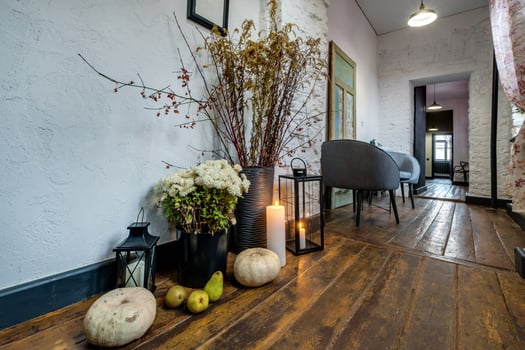 burning candles on a table with flowers with glasses or fruits, intimate romantic atmosphere photo