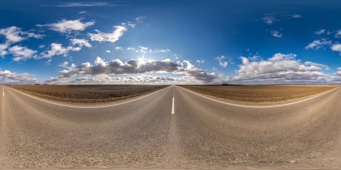 Full spherical seamless panorama 360 degrees angle view on no traffic asphalt road among fields in sunny day with cloudy sky. 360 panorama in equirectangular projection, VR AR content photo