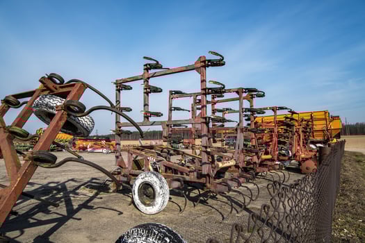Parking agricultural machinery and harvest. rows of plows, cultivators, bodies photo
