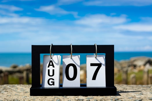 Aug 07 calendar date text on wooden frame with blurred background of ocean. photo