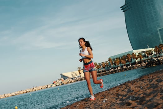 Filled with energy. Full length of attractive young woman in sports clothing jogging while exercising outdoors photo