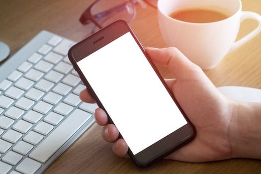 woman hands holding empty screen of smartphone on wood desk work photo