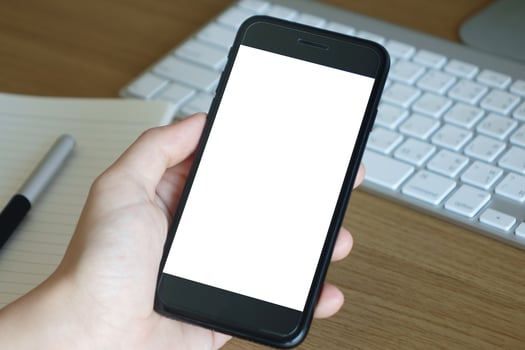 woman hands holding empty screen of smartphone on wood desk work photo
